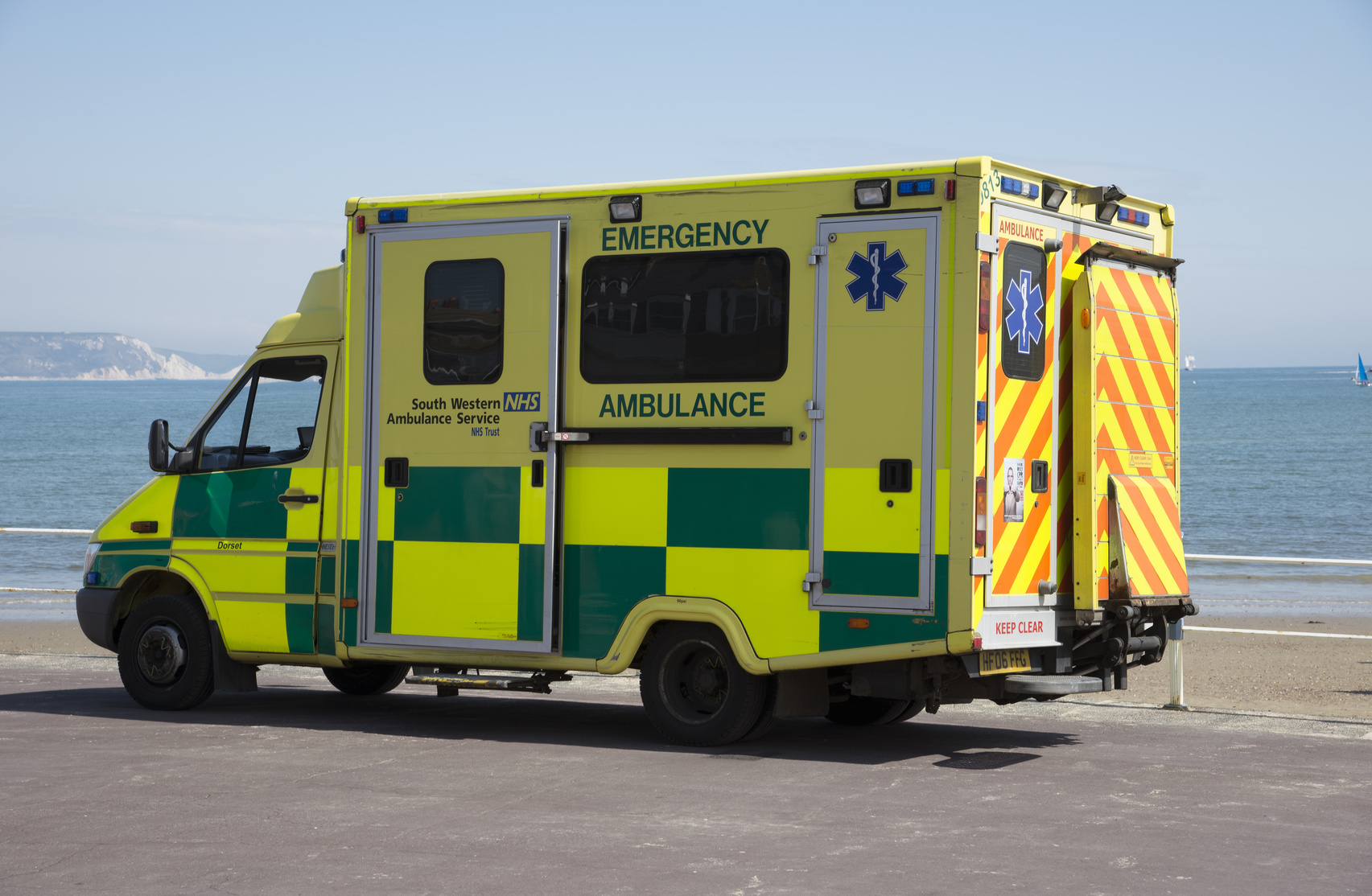 Emergency ambulance on standby at the seafront in Weymouth a seaside town in Dorset England UK